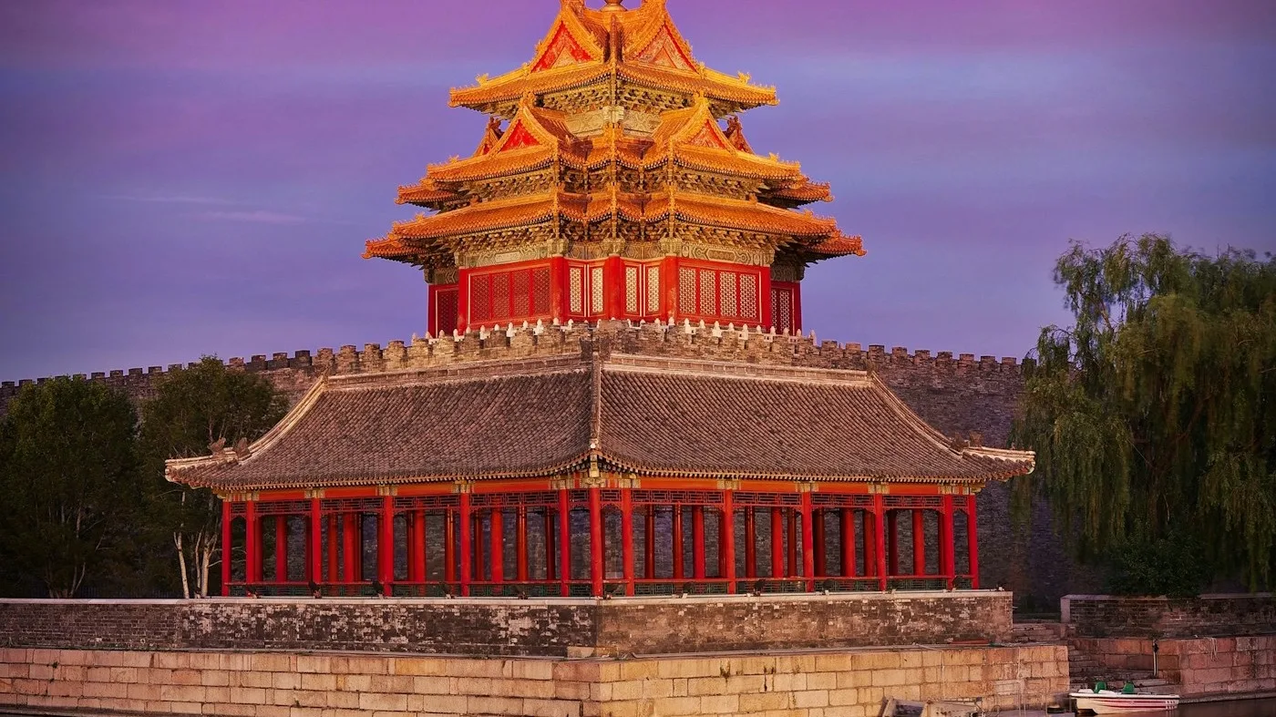 Forbidden City corner tower reflected in the moat at dusk in Beijing