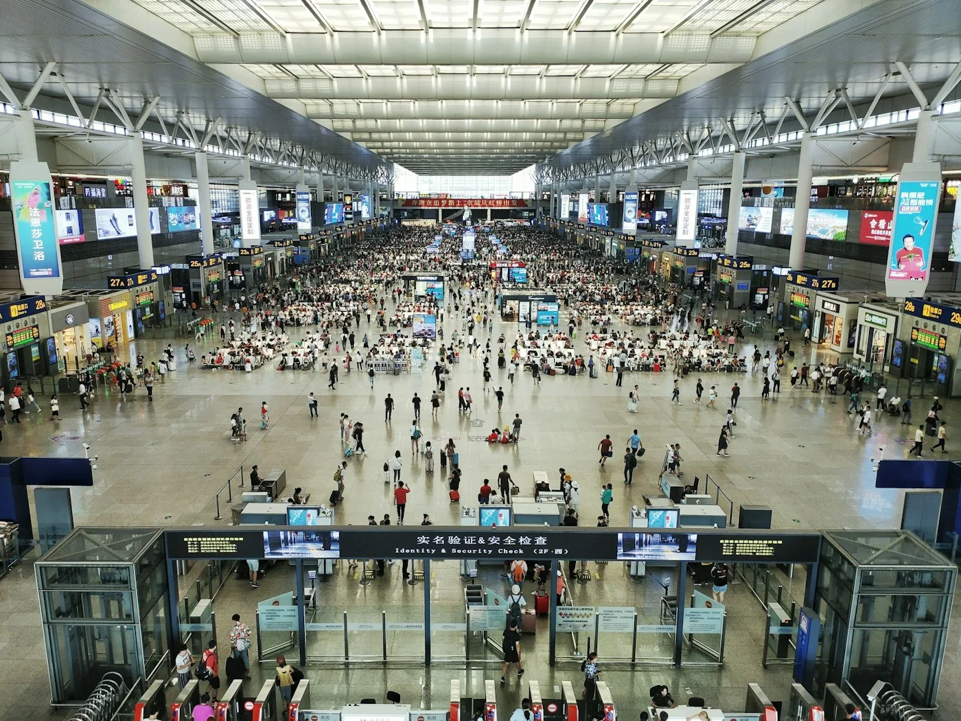 Travelers in a busy Shanghai railway station concourse