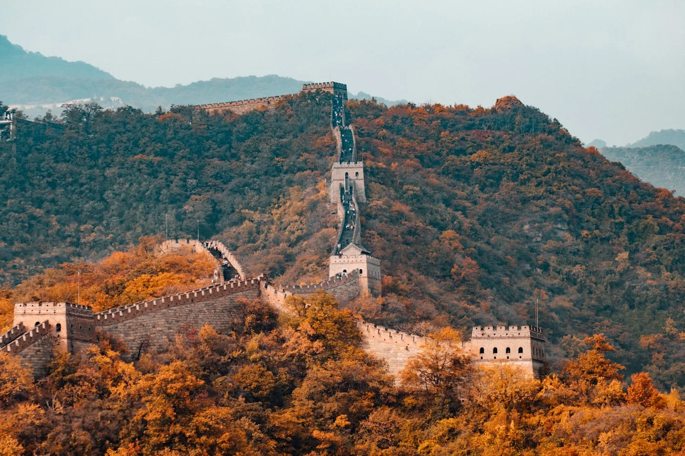 Great Wall of China winding over forested mountains at Mutianyu section