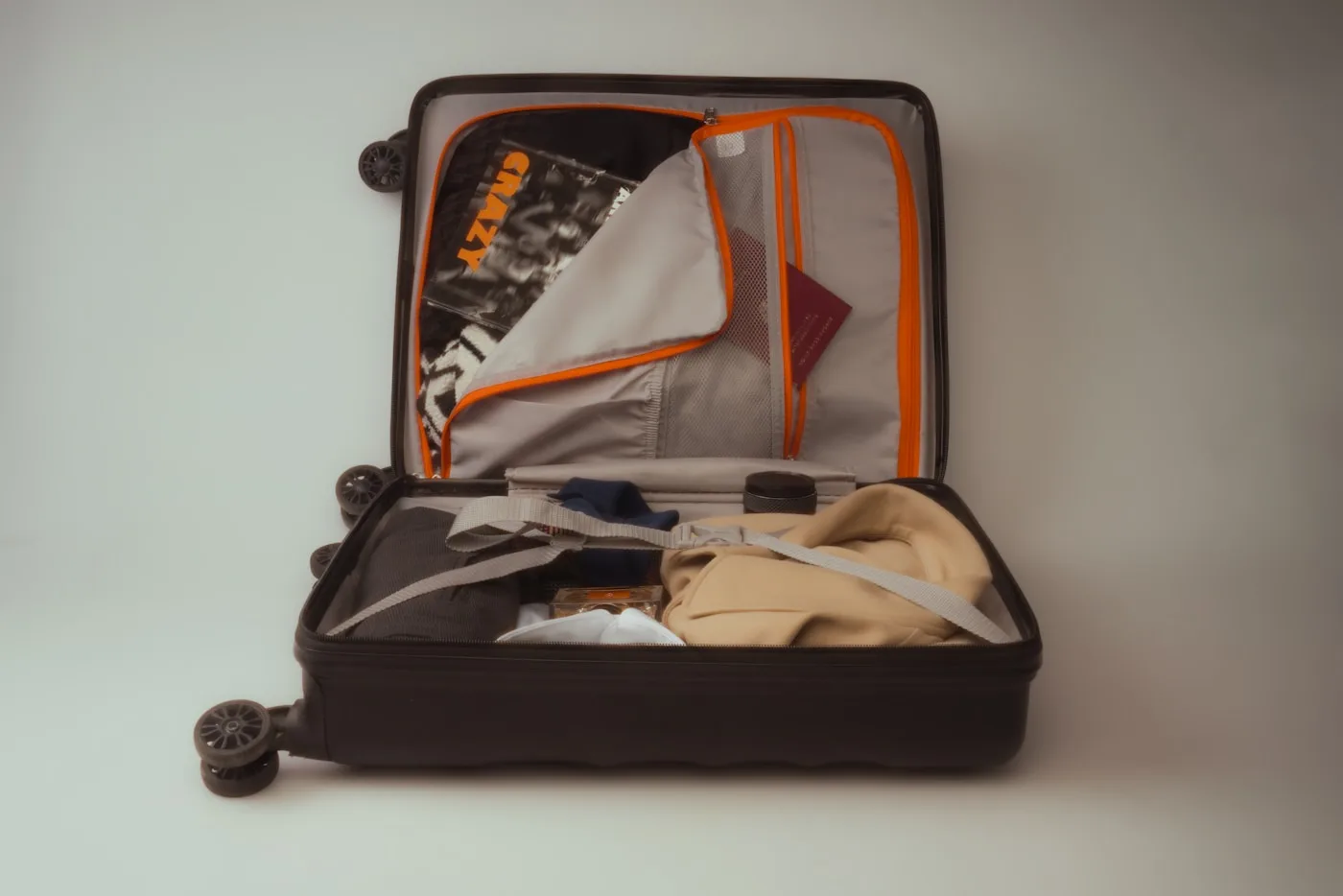 Open suitcase packed with clothes and travel essentials for China